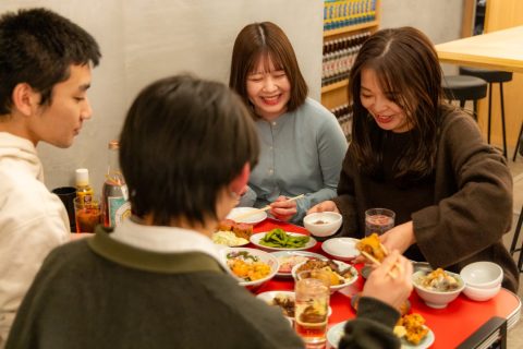 大衆食堂ニューヘイロー 下北沢のテーブルで料理を囲む様子